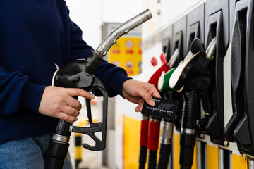 Card held near petrol pump during car refueling. © Rabizo Anatolii