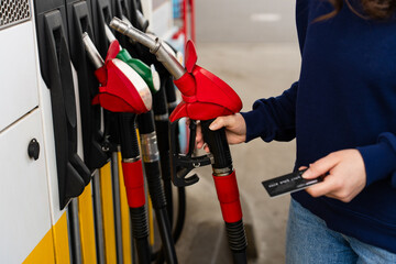 Card held near petrol pump during car refueling. © Rabizo Anatolii