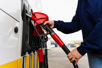 Driver filling car tank with gasoline nozzle close-up. © Rabizo Anatolii