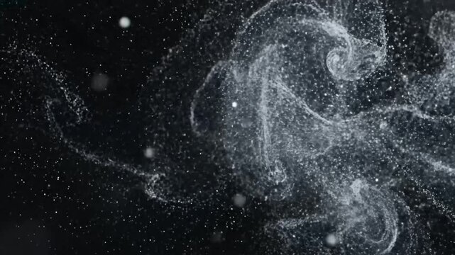 Abstract white particles exploding on a dark black background