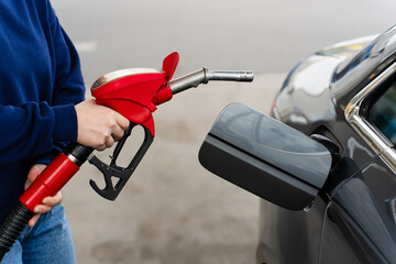 Fuel pump nozzle inserted into car tank during refueling. © Rabizo Anatolii