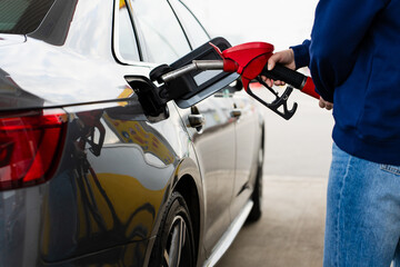 Close up of gasoline being poured into vehicle tank. © Rabizo Anatolii