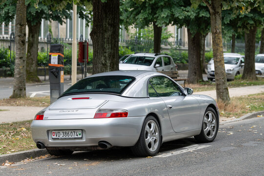 Nancy, France - July 9th 2025 : View on a grey Porsche 996 Carrera 4 Cabriolet with a hardtop parked on a street.