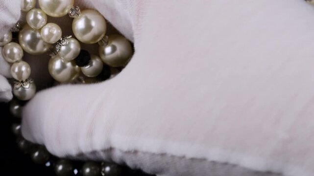 Elegant vintage multi-strand bracelets made of lustrous faux pearls and decorative beads. Close-up view of delicate craftsmanship and shimmering artificial gems.