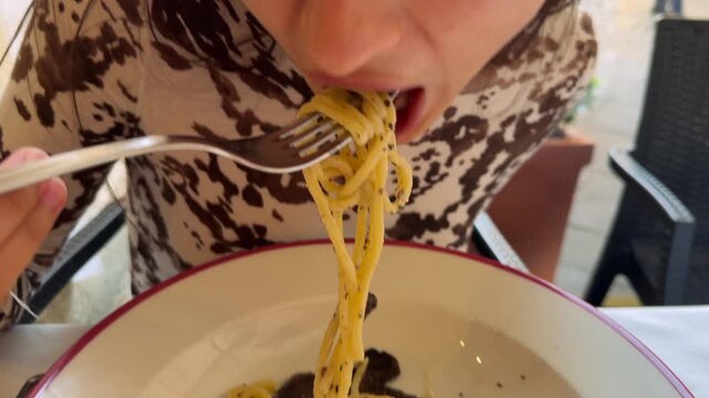 Woman Enjoying Pasta. Woman With Expressive Face Indulging In Rich Truffle Spaghetti On Busy Street