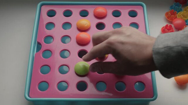 Bright tactile game. Vibrant sensory mosaic game for hands on engagement and education. Lively textured activity involving colorful elements on sensory stimulation board for learning