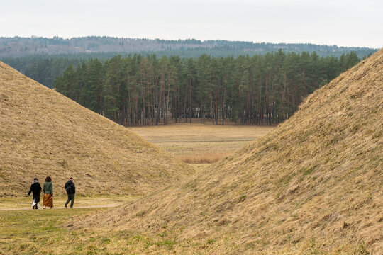Walking between the hillforts and the mounds of Kernave in early spring, Lithuania, the medieval capital of the Grand Duchy of Lithuania, UNESCO world heritage, a tourist attraction