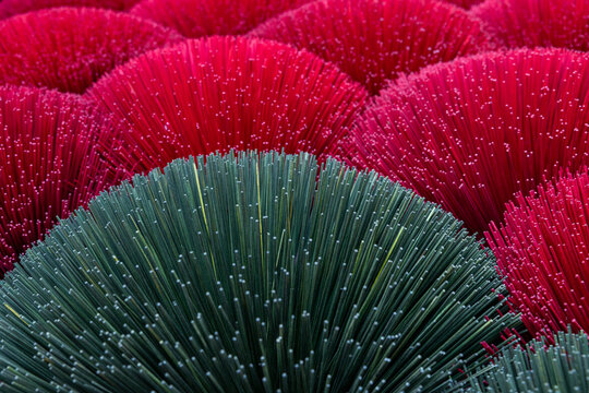 Close up of colorful green and red incense sticks
