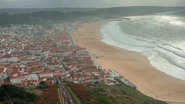 Churning ocean waves near deserted beach under ominous skies