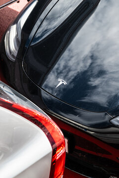Gothenburg, Sweden - July 14 2024: Closeup view of black Tesla hood with bright reflections.