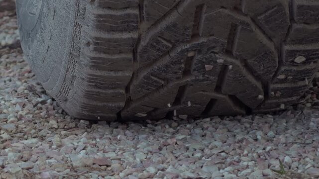 Rugged tire traction. Highdefinition shot capturing intricate pattern of tire pressing into gravel surface