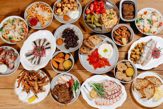 Appetizer and tapas table spread for casual party with bread, salads and seafood