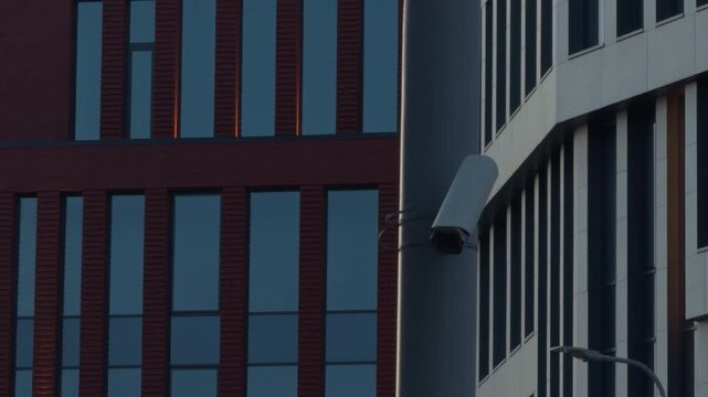 Dusk urban architecture. Slow motion footage of tall red office structure with precise geometric details at twilight