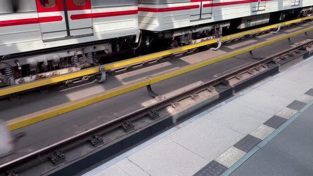 White red train doors sliding close along platform, threshold and tracks glimpsed, blue LED guide and commuter boarding cues. Subway in Europe.