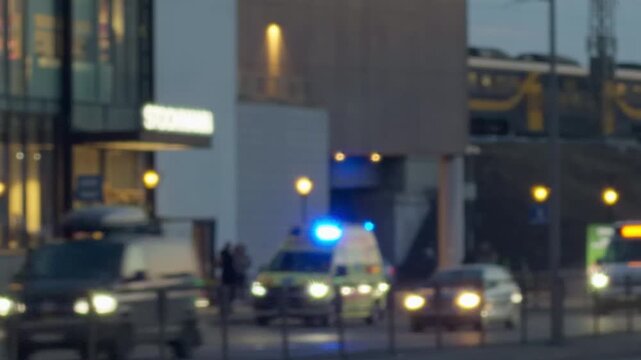 Ambulance amid bustling traffic scene. Emergency services navigate busy roads with blurred vehicle foreground