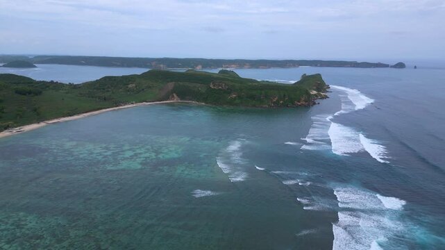 Aerial Reef Lagoon With Long Sheltered Bay, Clear Shallow Flats And Turquoise Channels, Gentle Breakers Along Outer Reef, Narrow Sandy Shoreline, Katil beach,Kuta,Lombok,Indonesia