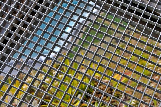 Abstract green mosaic background of urban skyscrapers with glass windows, steel structures and square patterned reflections in a modern city architecture texture