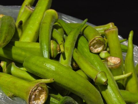 Okra Pods in Plastic Bag with Black Background