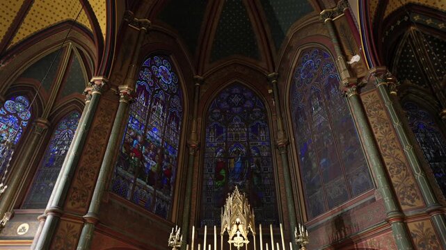 Stained glass windows and gothic arches in Paris church interior