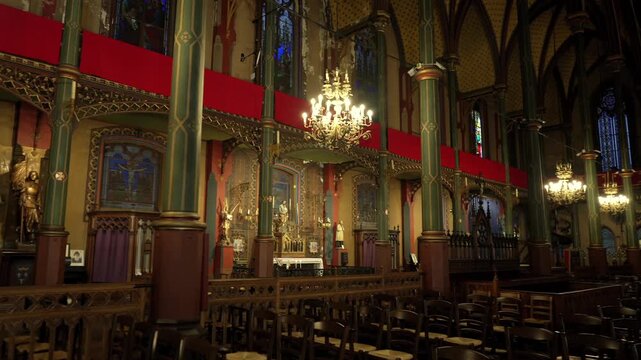 Church interior with chandeliers columns and empty chairs Paris France