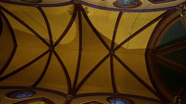 Ornate gothic ceiling with vaulted arches in Paris church interior France