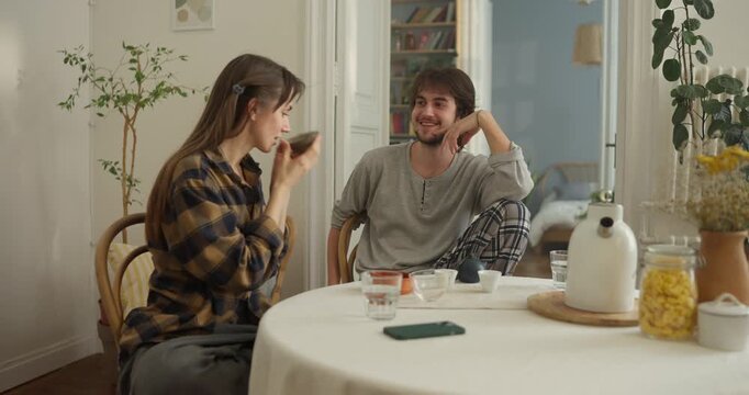 In a cozy kitchen, two friends share tasty treats and laughter on a sunny afternoon