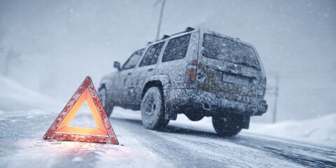 Vehicle with snow on top driving down the road. Cautionary sign warning drivers of slippery conditions.