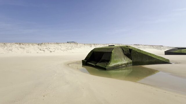 German World War II blockhouses now in the middle of Cap Ferret beach after dunes retreated over 150 meters in recent years due to coastal erosion, Atlantic Wall remains exposed to ocean