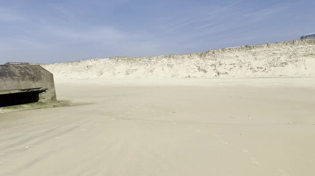 German World War II bunker stranded on the beach of Cap Ferret in southwest France after coastal erosion, originally built on top of the dune decades ago, Atlantic Wall relic facing ocean
