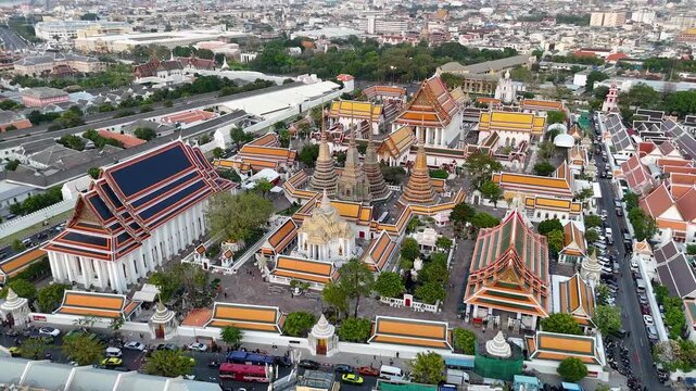 Bangkok, Thailand: Aerial view of Wat Pho Thai Buddhist temple complex (Temple of the Reclining Buddha) in heart of Thai capital city, Grand Palace on horizon - landscape drone panorama