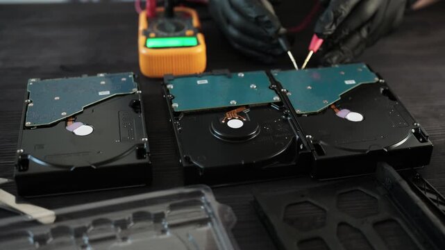 Gloved Technician Tests A Damaged Hard Disk Drive During Computer Hardware Diagnostics In A Service Center