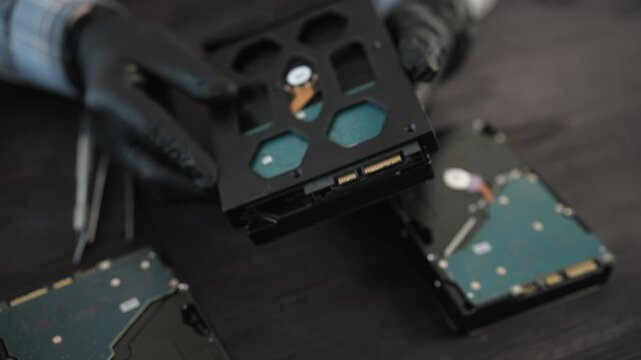 Service Technician Holds A Hard Disk Drive During Computer Storage Hardware Maintenance In Service Center