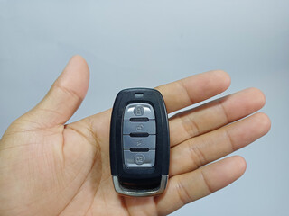 Fototapeta premium Remote Control for Car and Motorcycle Alarm in Hand Isolated on White Background
