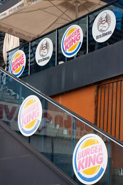 Batumi, Georgia - June 27, 2025: Vertical photo. Logo of chain Usta Donerci, Burger King on stairs of fastfood restaurant. Concept of pick up order, dinner, lunch, fast food, diet, menu, eat