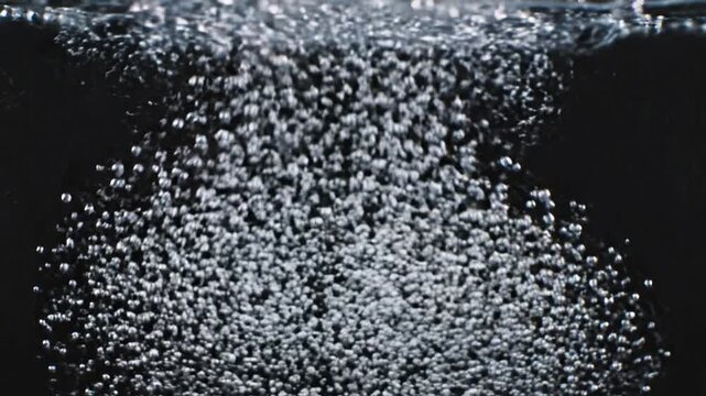 Bubbles Ascending: A captivating display of bubbles rising in water, their forms reflecting the play of light against a dark background, evoking a sense of buoyancy and natural effervescence.
