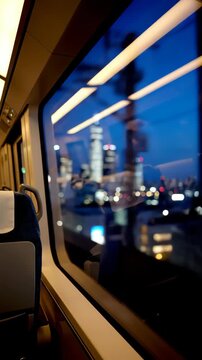 View from train window at night city lights blurred motion.