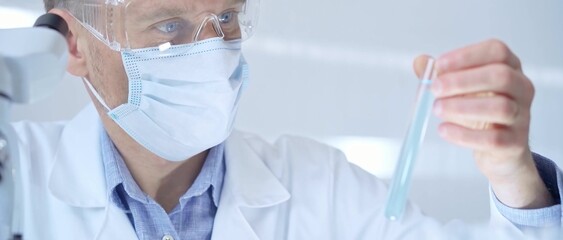 Fototapeta premium Scientist researcher with protective glasses and mask examining
