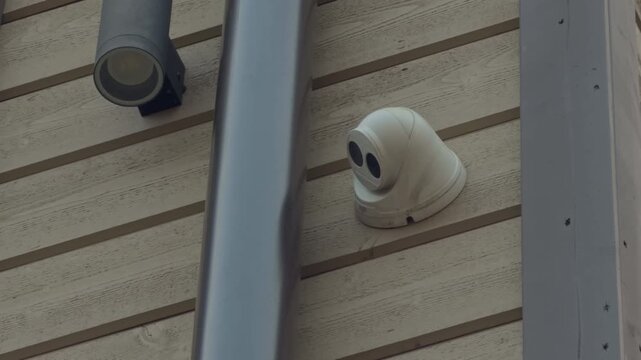 Security device watches building perimeter. Monitoring equipment installed on walls for neighborhood protection