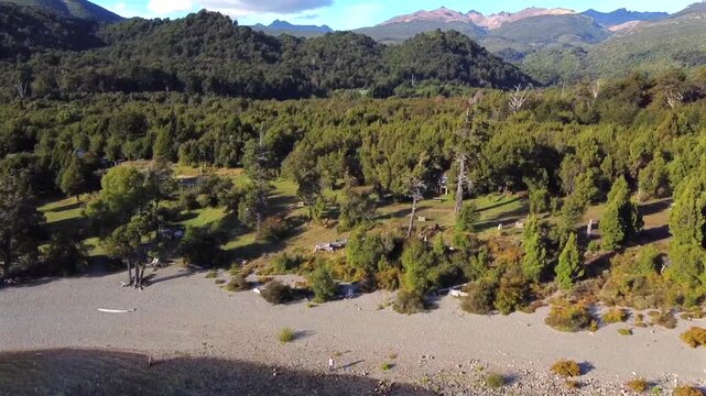 Aerial shot from Lago Futalaufquen towards Bahia Rosales beach in Argentine Patagonia near Esquel Chubut. The forest and camping sector are visible at sunset.