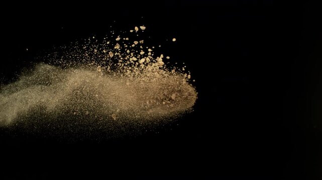 Super Slow Motion Shot Flying Soil, Rocks and Dust Isolated on Black at 1000fps.