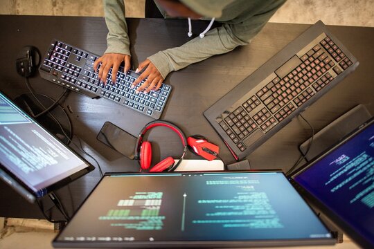 Programmer working on multiple screens
