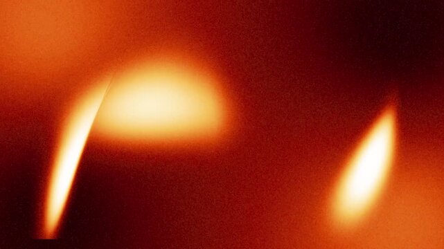 A video showcasing a close-up view of vibrant orange flames burning brightly in the darkness