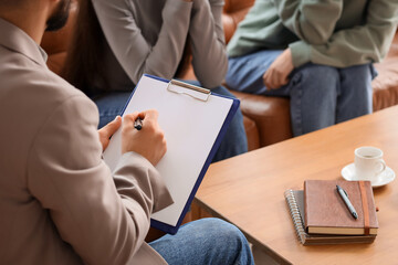 Male family mediator working with lesbian couple in office, closeup