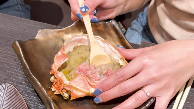 Close Up of Person Eating Japanese Crab Miso in Tokyo Restaurant