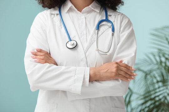 Beautiful young African-American female doctor with stethoscope in clinic, closeup