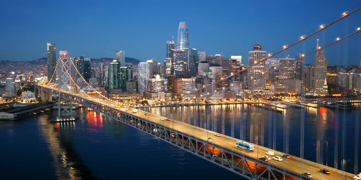 San Francisco - Perfect Establishing Shot of SF Skyline over Bay Bridge at Blue Hour Sunrise Dawn with City Lights and Light Traffic