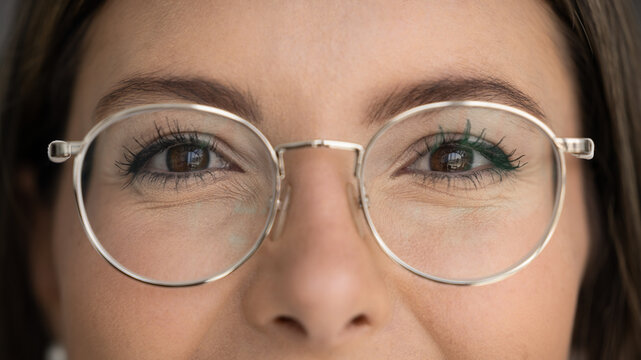 Close up shot of young 30s attractive cropped view woman face wearing modern, round eyeglasses. Vision, eyewear store advertisement, promoting eye-care professional eyesight clinic check-up services