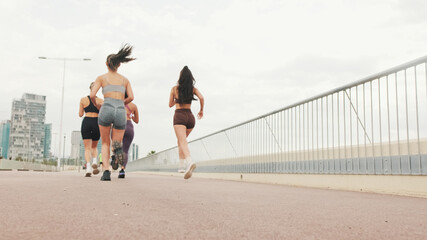 Naklejka premium Women Running on Boardwalk for Fitness and Fun