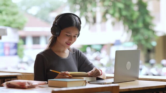 Young Asian Woman University Student Using Laptop for Learning
