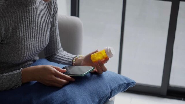 Asian Girl reading information online on mobile phone&nbsp;medicine